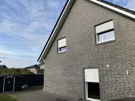 Seitenanansicht - Zweifamilienhaus in 26899 Rhede mit 209m² kaufen