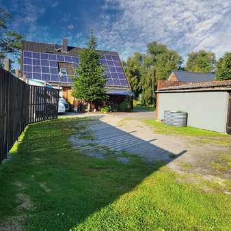 Gartenansicht mit Solaranlage - Einfamilienhaus in 21762 Otterndorf mit 185m² kaufen