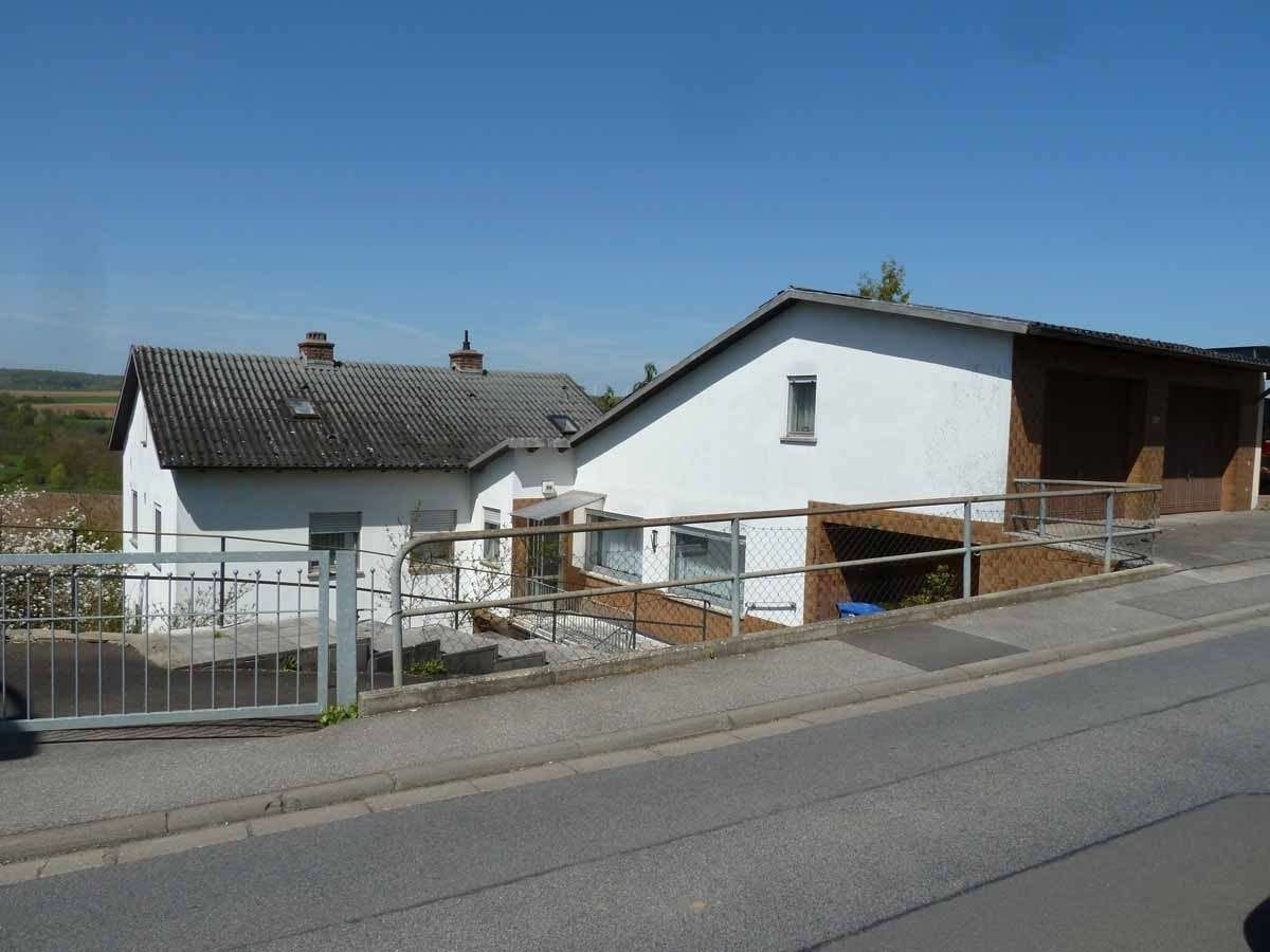 Südostansicht des Hauses mit Anbau/Garage (Straßenseite) - Zweifamilienhaus in 97437 Haßfurt mit 200m² kaufen